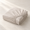 Solenne Deep-Pocket Fitted Sheet, complete set on a quiet studio surface